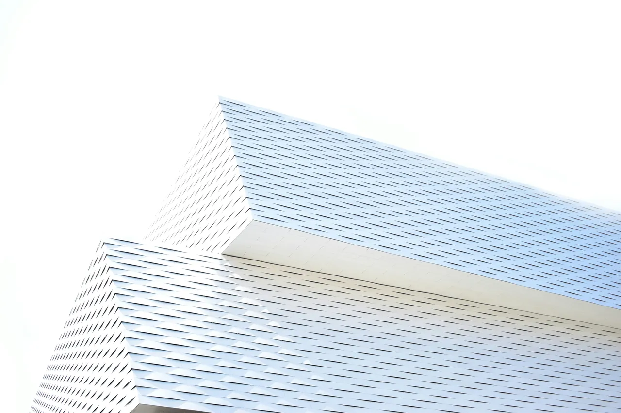 The bright louvred facade of Messe Basel — a grid of identical rows